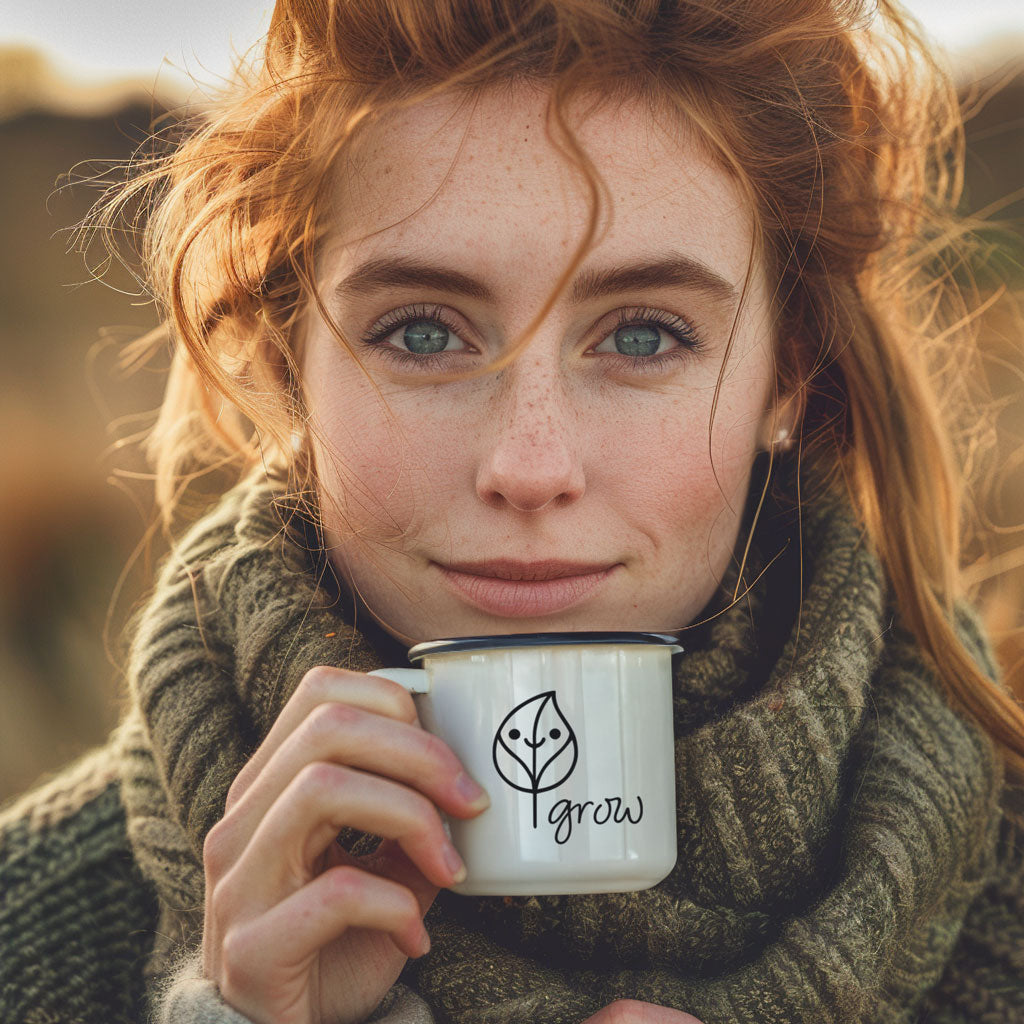 Eine rothaarige Frau schaut geradeaus und trinkt aus einer awa7 Grow Emilie-Tasse